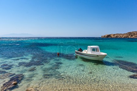 Small boat in Paranga Beach on the island of Mykonos, Greece