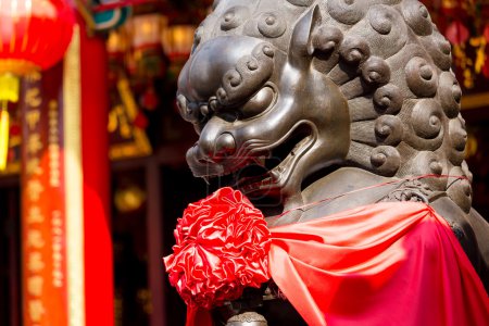 lion statue in front of chinese temple