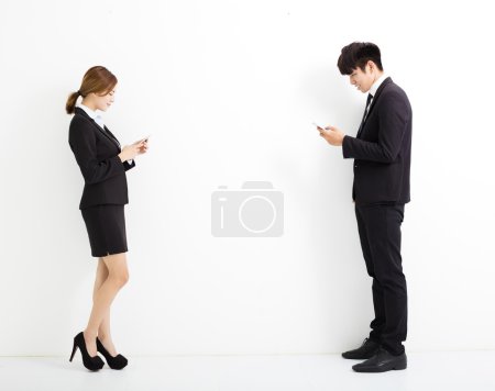 年轻的商界男人和女人拿着智能手机 