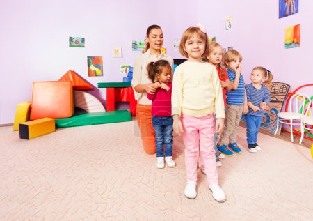 kids  in kindergarten with teacher