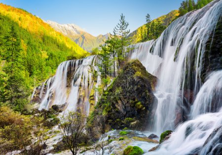 Scenic view of the Pearl Shoals Waterfall among woods at sunset