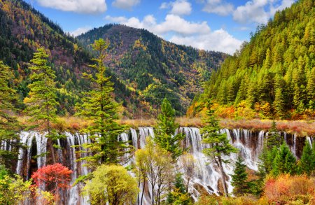 The Nuo Ri Lang Waterfall (Nuorilang) among woods and mountains