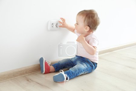 Baby playing with electrical outlet 