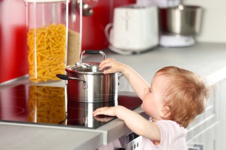 Little child playing with pan 