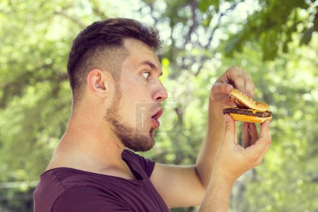 man eating a hamburger