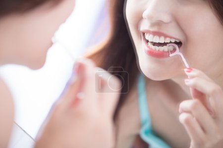 Smile woman with teeth floss