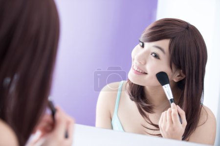 Woman using makeup brush