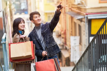 happy young asian couple going on a shopping spree