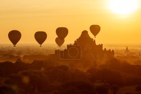 air balloons over Buddhist temples at sunrise. Bagan, Myanmar.