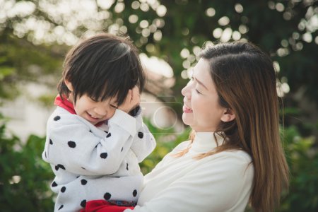 幸福的母亲和她的儿子在公园里玩