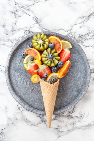 Ice cream cone with fresh fruits