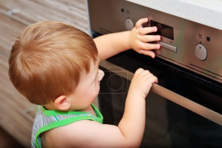 Child playing with electric oven