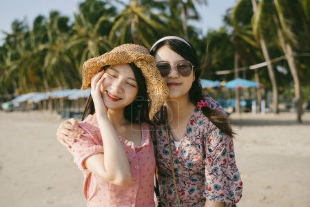 两个女孩在海滩上一起欣赏的肖像.