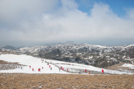 Many tourist playing snow in Valley of the Blue Moon in Shangri-