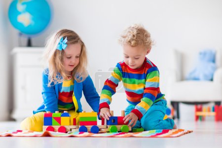 Kids playing with wooden toy train