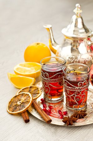 Traditional arabic tea with metal teapot and glasses vertical