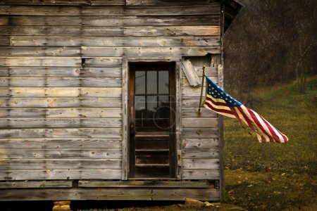 American Flag hanging on an old barn