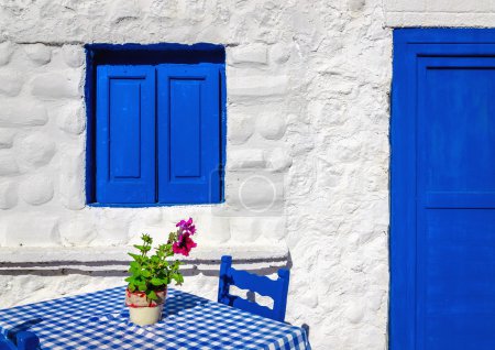 blue table with wooden chairs , Greece