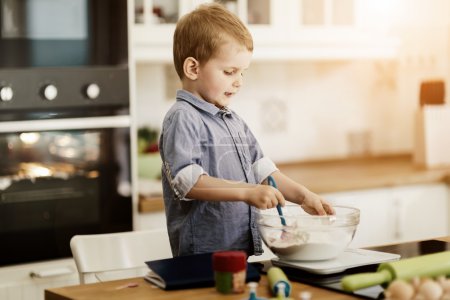 Cute child learning to become a chef