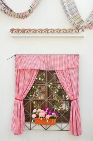 Window decorated with blinds and flowers