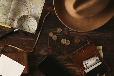 Top view adventure planning acsessories on wooden table