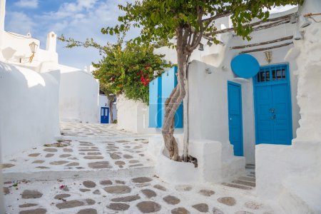 Mykonos streetview with blue door and trees, Greece