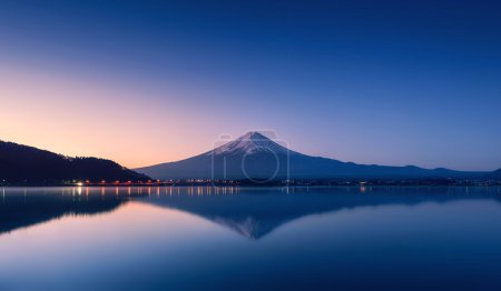 mountain Fuji at dawn with peaceful lake reflection