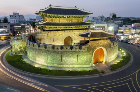 Late night traffic blurs past Paldalmun Gate in Suwon, South Kor