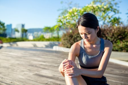 Woman with pain in knee joint 