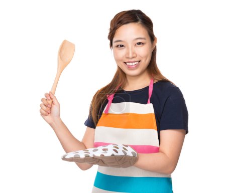Asian Housewife hold with wooden ladle and oven gloves