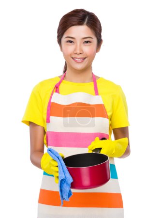 Asian Housewife washing the saucepan