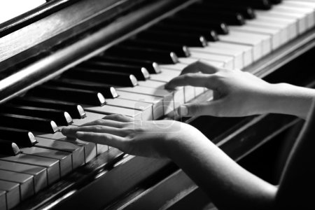 Little girl hands piano playing