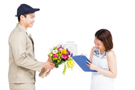 Delivery man taking signature of woman