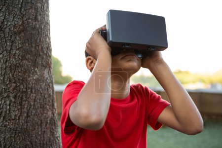 Elementary boy using virtual reality headset