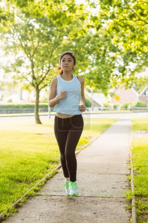 Woman jogging through the park