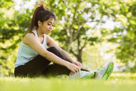 Woman ties shoelace