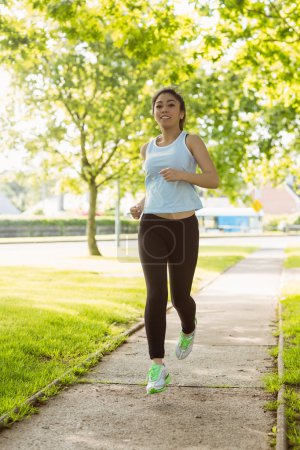 Woman jogging through park