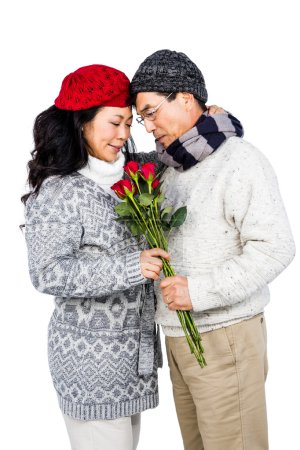 Older asian man giving his wife flowers