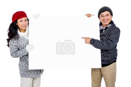 Portrait of couple with blank cardboard
