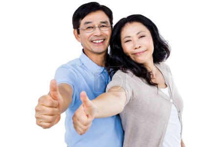 Couple standing together with thumbs up