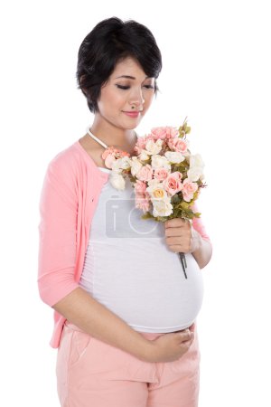 Beautiful asian pregnant woman holding a flower bouquet