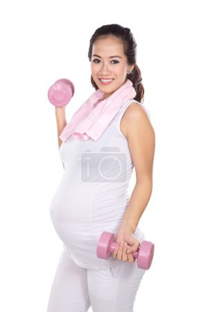 Beautiful asian pregnant woman working out with weights isolated