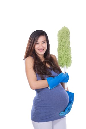 Asian pregnant woman holding a wiper while smiling on white back