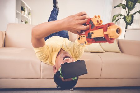 Adult man with gun and VR glasses