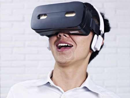 Young asian man wearing VR goggles