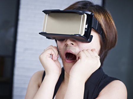 Young asian woman trying VR glasses