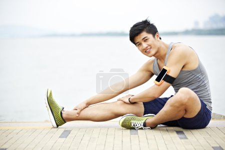 Young asian man exercising outdoors