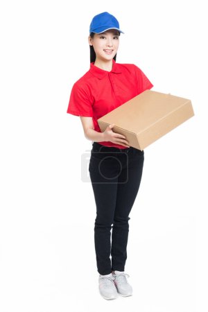 Delivery woman carrying cardboard box