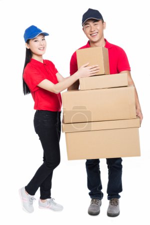 Young man and woman carrying cardboard box