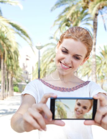 woman taking a selfie picture of herself on a summer vacation